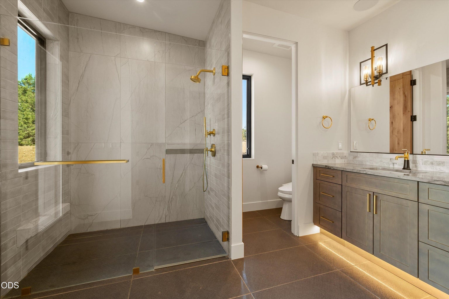 Walk-in shower and separated water closet finish the primary ensuite
