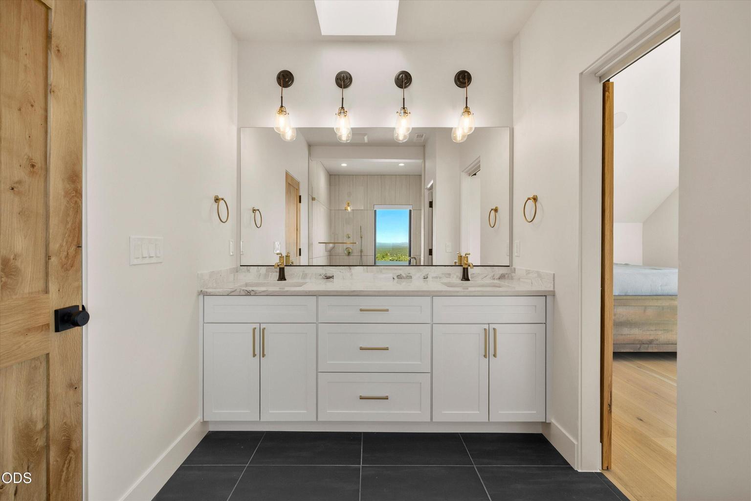 A jack-and-jill bathroom upstairs with double vanity