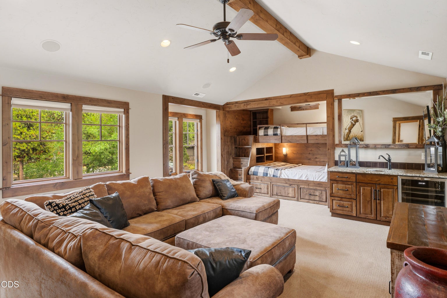Upper-level bonus room offers the ultimate gathering space with custom built-in bunk beds, a wet bar with beverage refrigerator, and ample room for movies, games, and relaxing after a day of adventure.