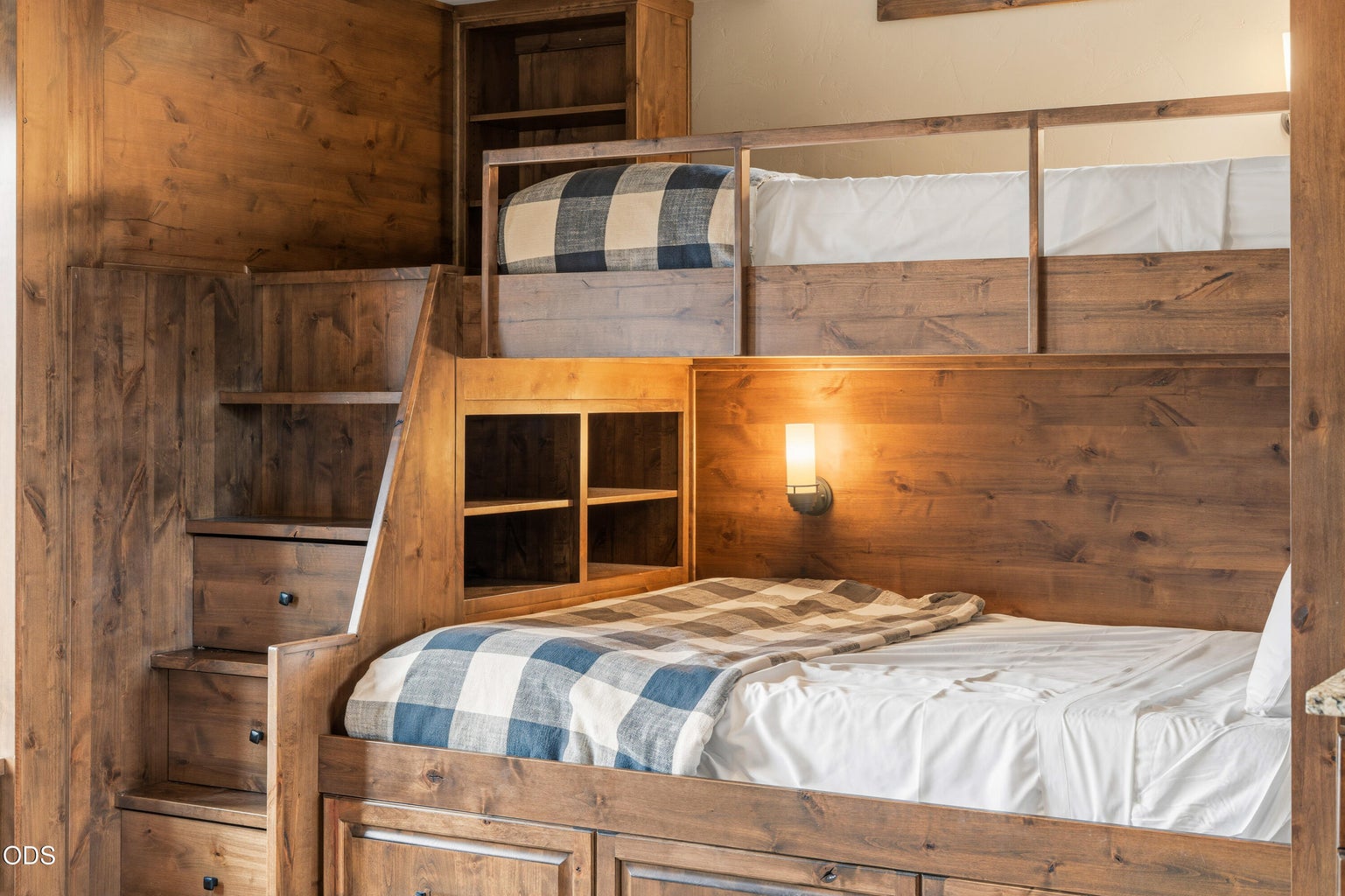 Custom built-in bunk beds with integrated storage provide a fun and functional sleeping space, making this bonus room perfect for guests, kids, or multi-family gatherings.