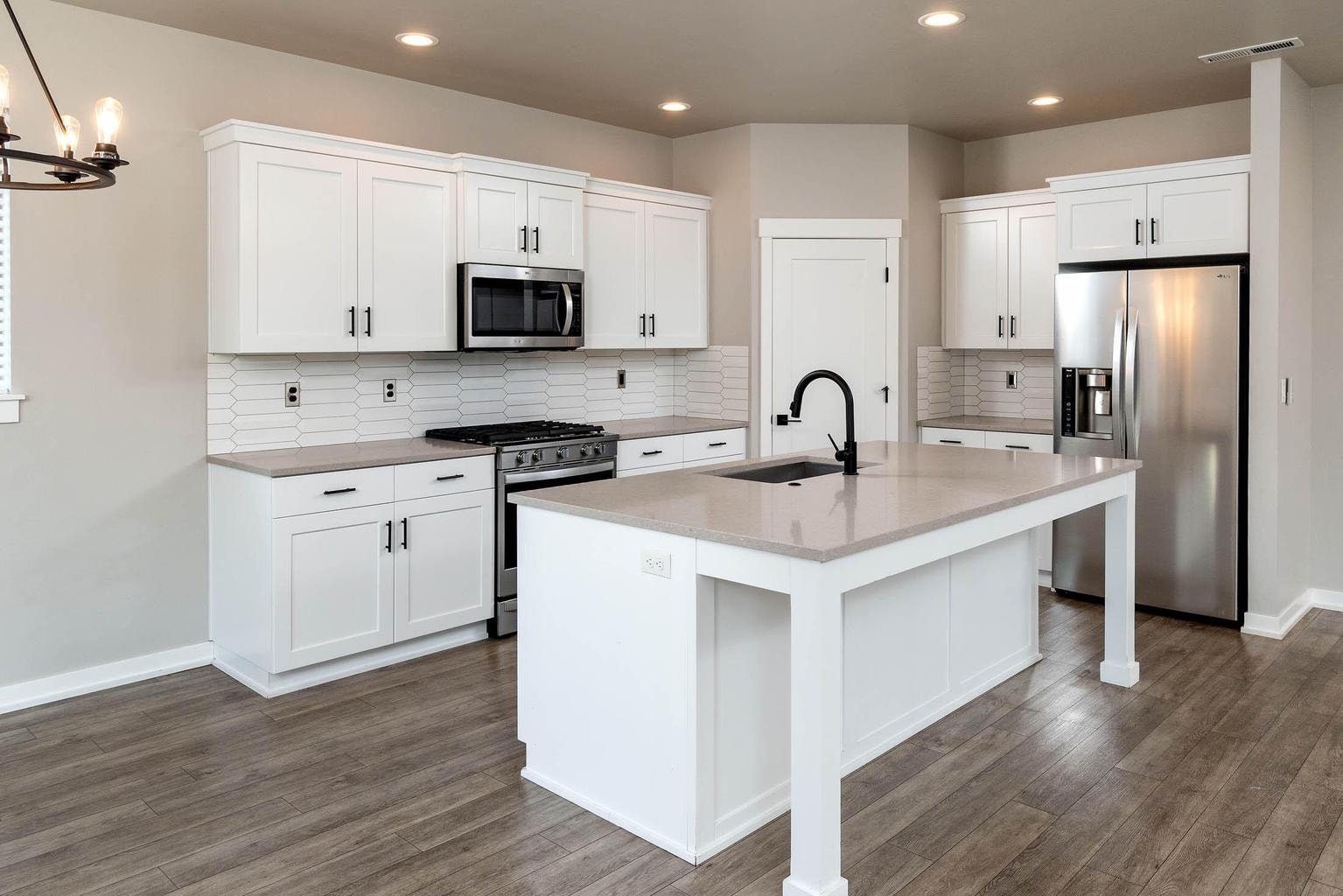 Kitchen with quartz counter tops, SS appliances and island