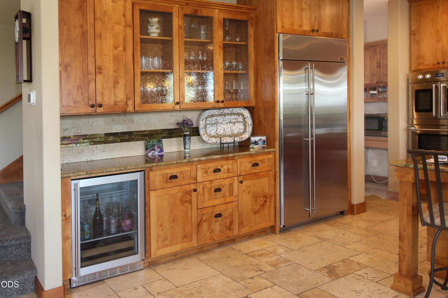 The wet bar with beverage fridge. Sink nearby in the huge island.