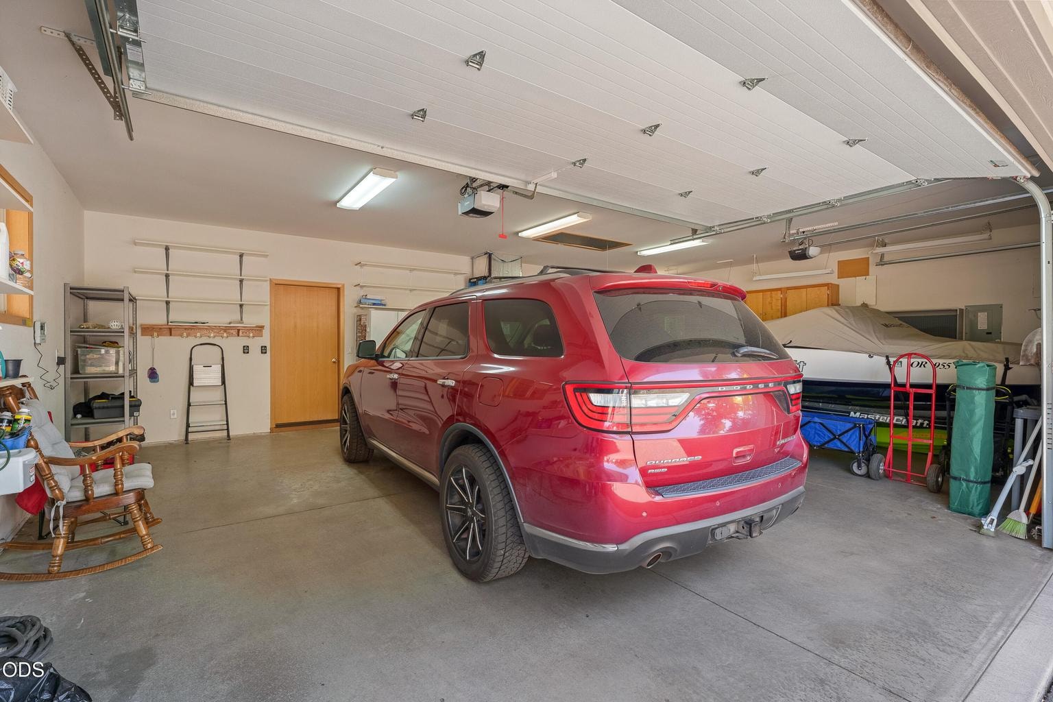 Oversized 3 car garage with workbench and accessible attic.
