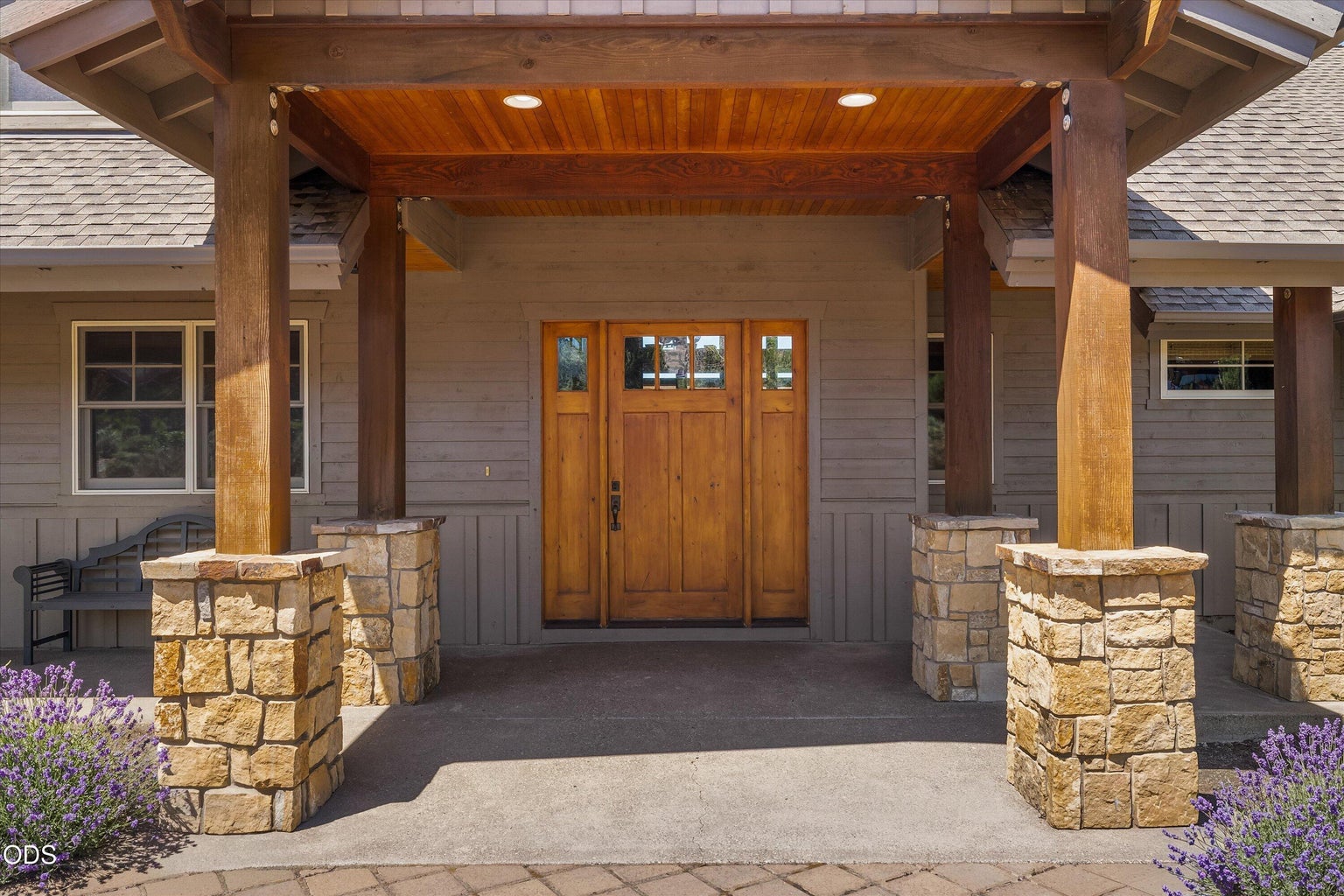 Covered front patio with Northwest stone and wood touches