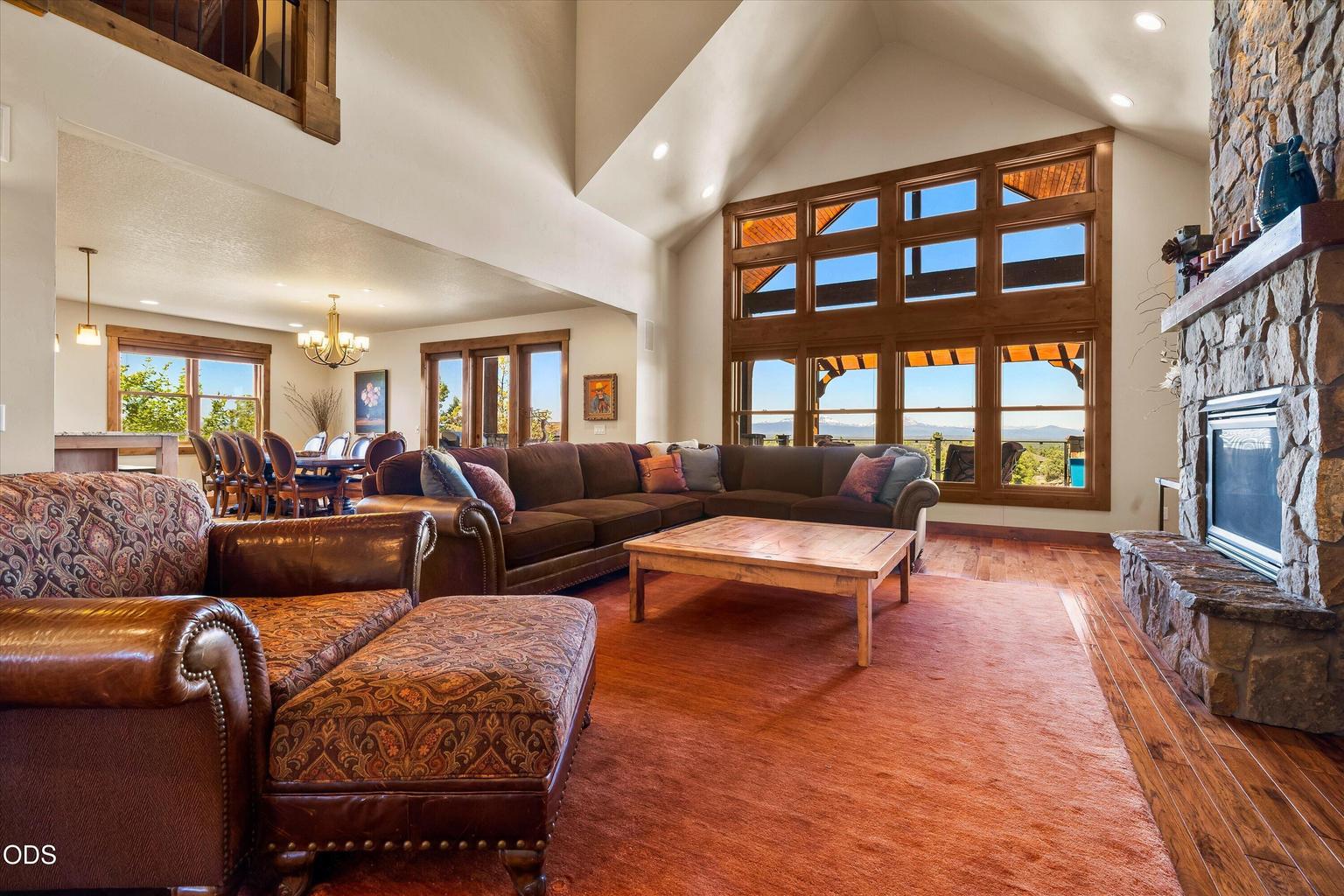 Great room features vaulted ceilings, great windows to capture the mountain views, floor-to-ceiling stone fireplace