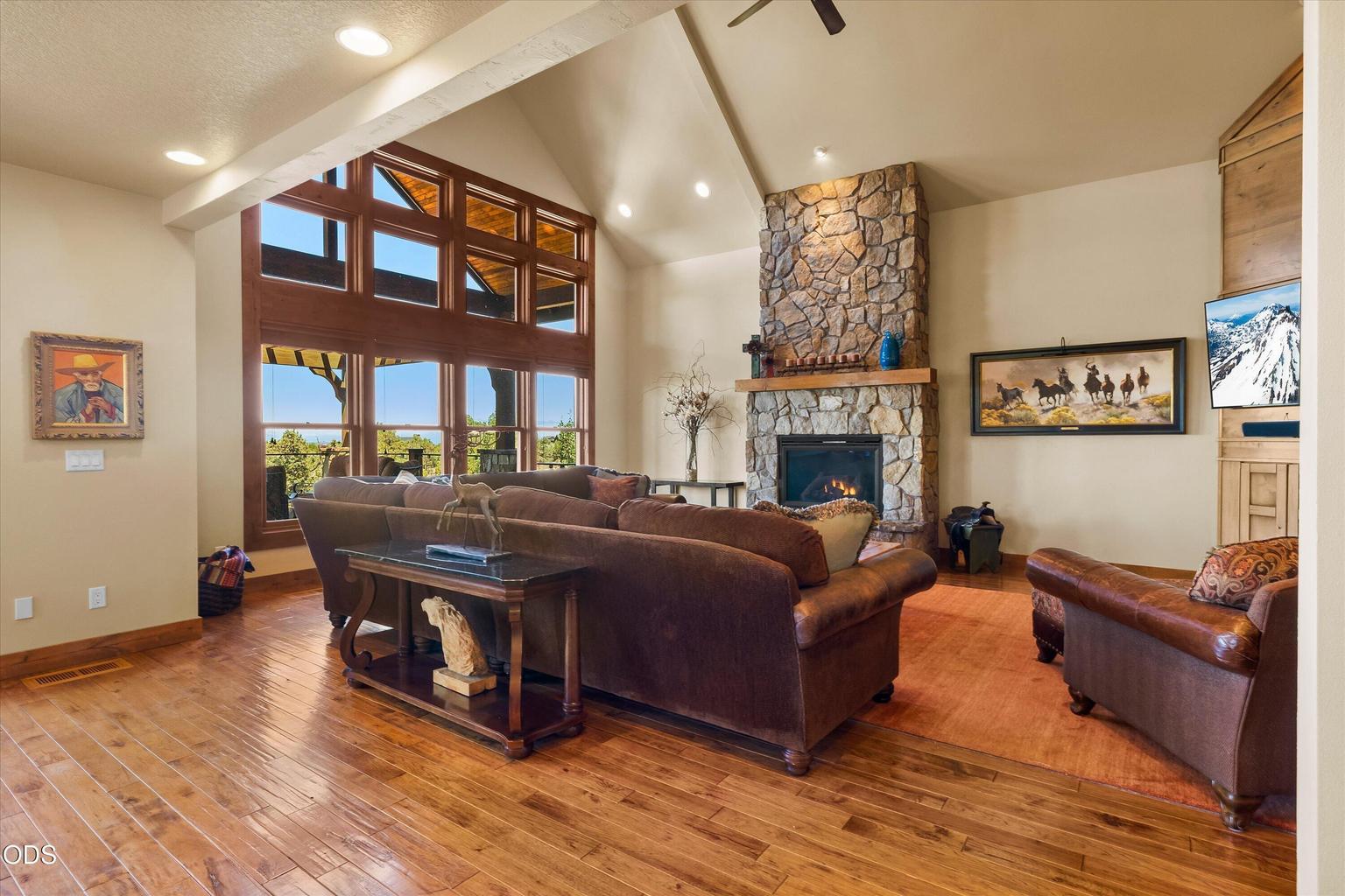 Beautiful hardwood floors, stone fireplace, and built-in frame the spacious Great Room