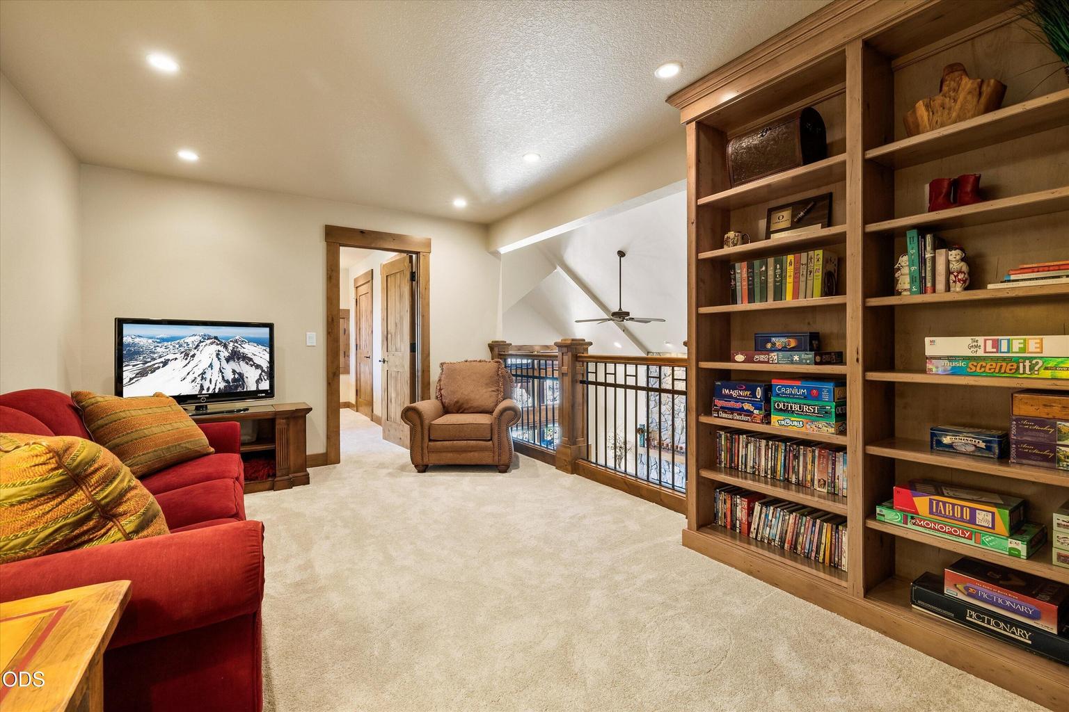 At the top of the stairs sits a loft overlooking the Great Room, with built-in libraray