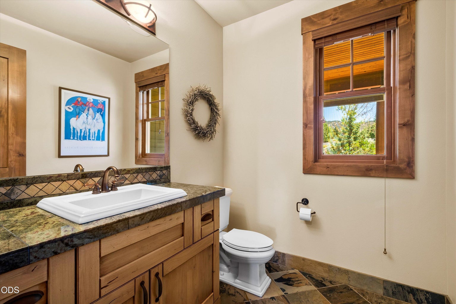 From a hallway off the grand foyer find a powder room for guests