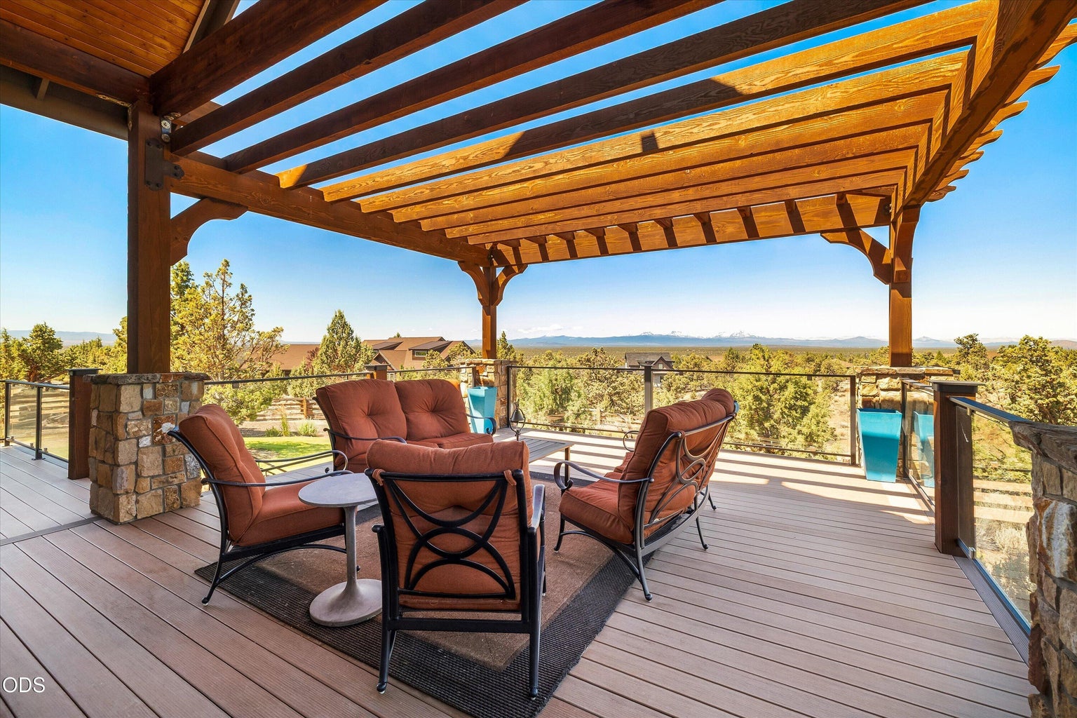 Oversized covered deck added in 2018 features areas for lounging, dining, and cooking