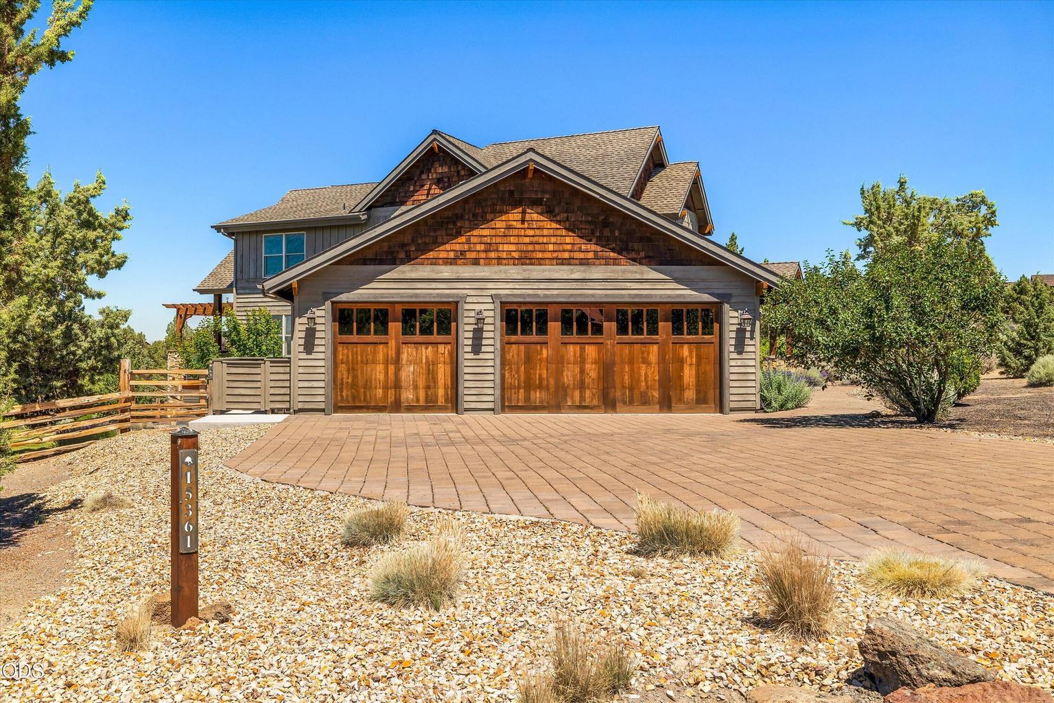 Special touches like the original lot marker, fence and gates, paved driveway, wood garage doors