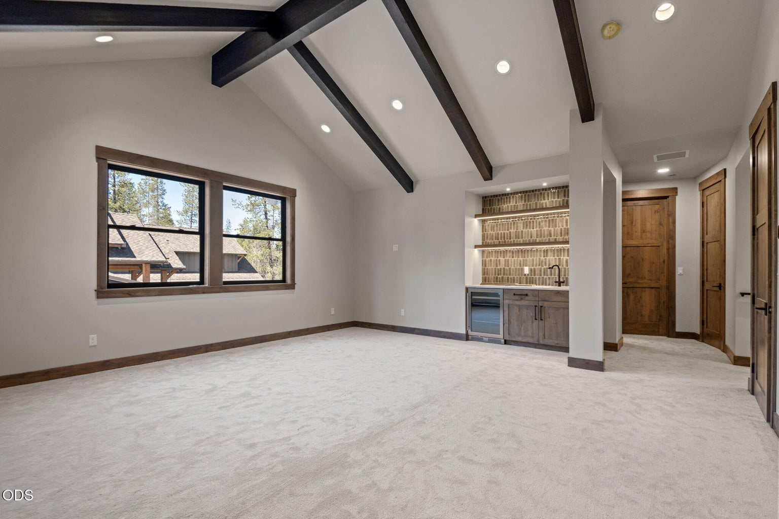 Media / bonus room upstairs with vaulted beamed ceilings