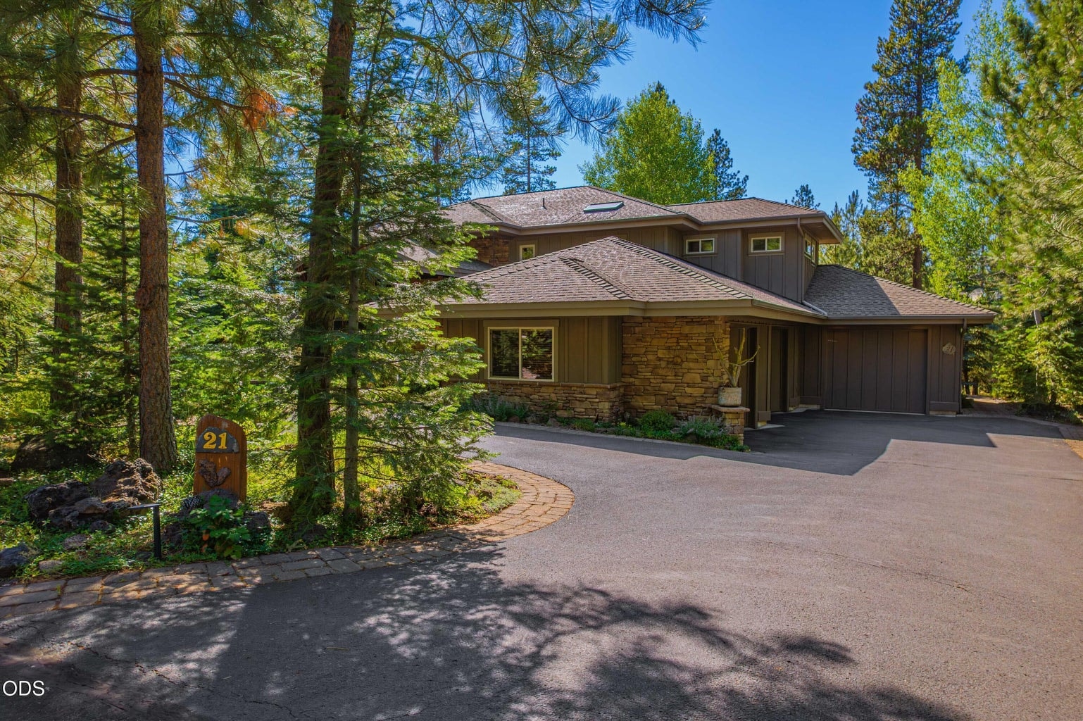 Set among mature pines and carefully integrated into its forested homesite, this substantial Sunriver residence offers natural stone accents, an inviting approach and a three-car garage.