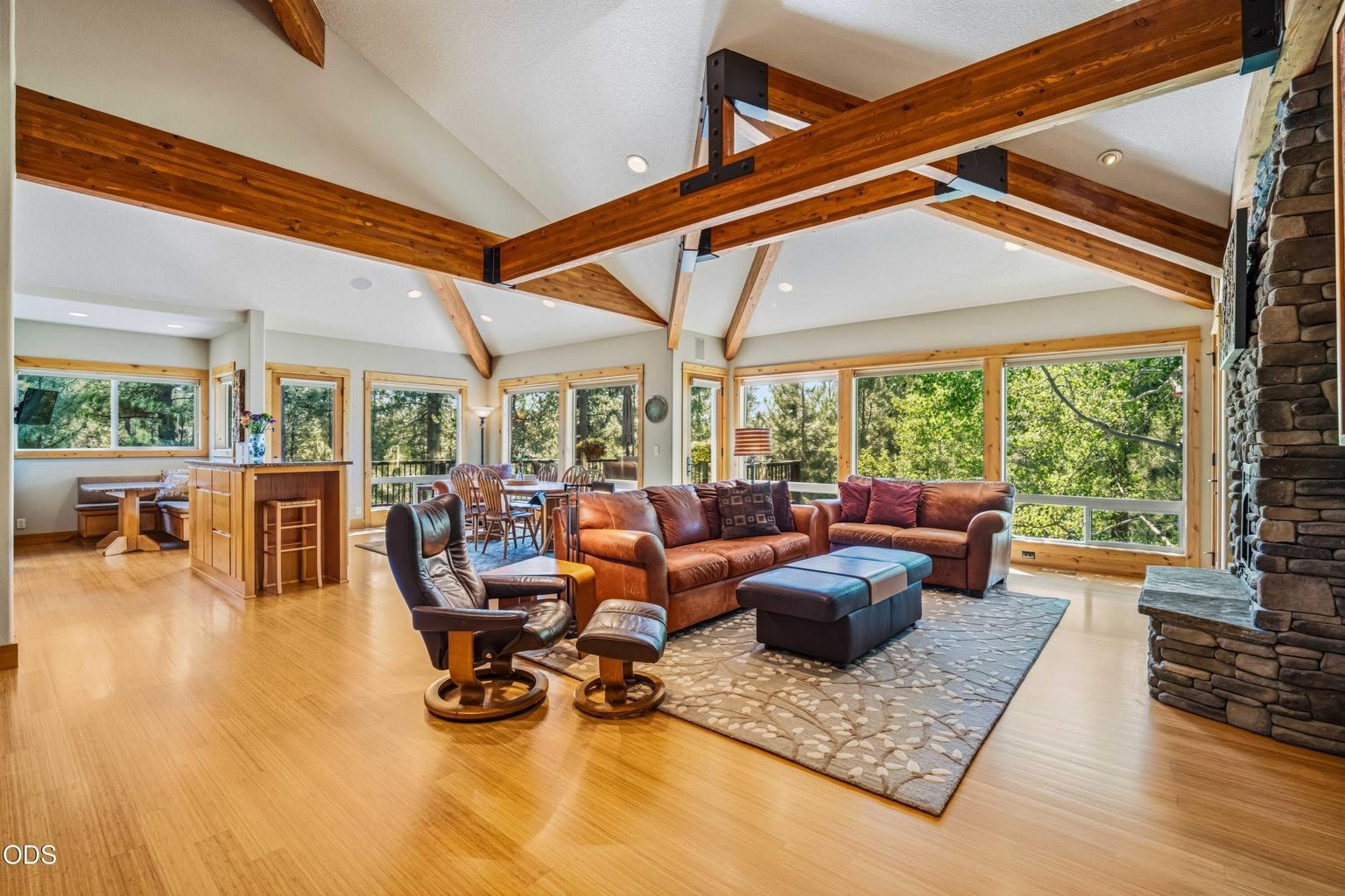Walls of windows bring the surrounding forest directly into the dramatic great room, where exposed structural beams, bamboo flooring and generous living space create an exceptional setting for full-time Sunriver living. 57733 WALLOWA LOOP, SUNRIVER, OR 97707