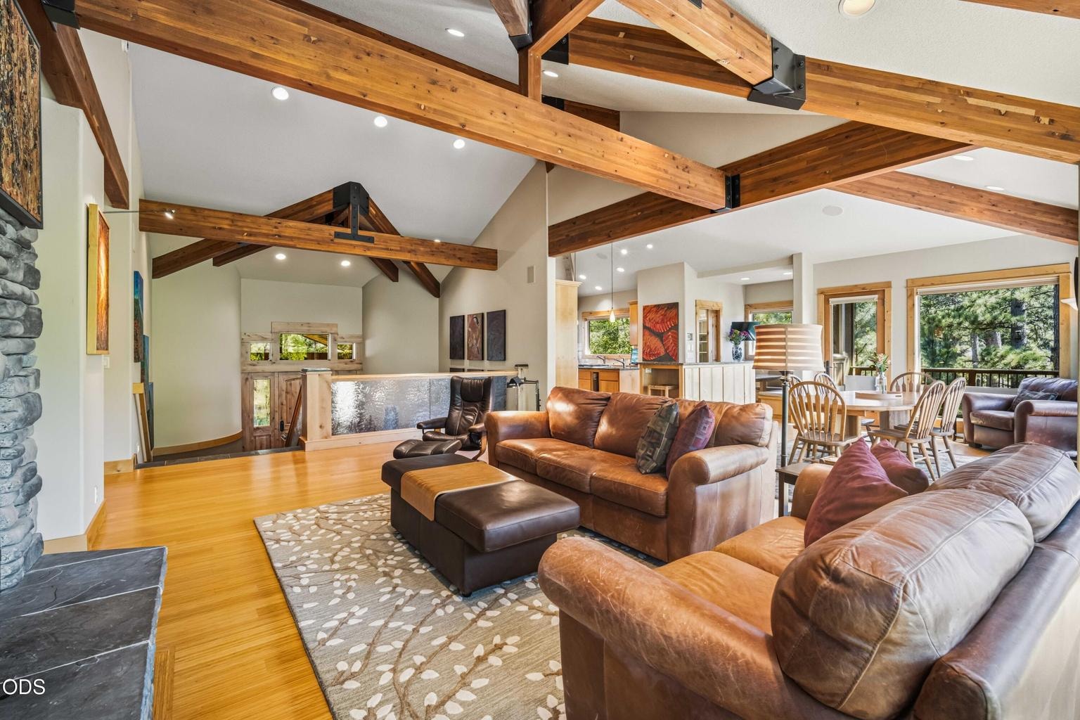This wide view demonstrates the impressive scale and openness of the primary living level, connecting the great room, dining area, kitchen and entry while preserving clearly defined spaces for comfortable everyday living.