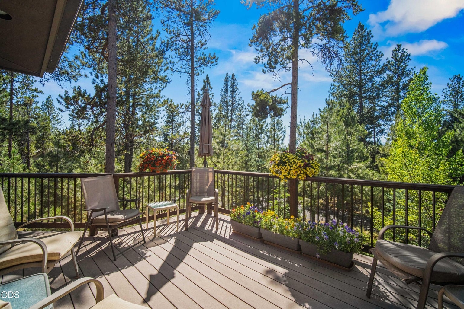 The expansive wraparound deck outside the dining area creates a generous outdoor living space surrounded by mature pines, aspens and colorful planters. Oriented toward Mt. Bachelor, it offers room for conversation, outdoor dining and relaxed enjoyment of the exceptional Sunriver forest setting.