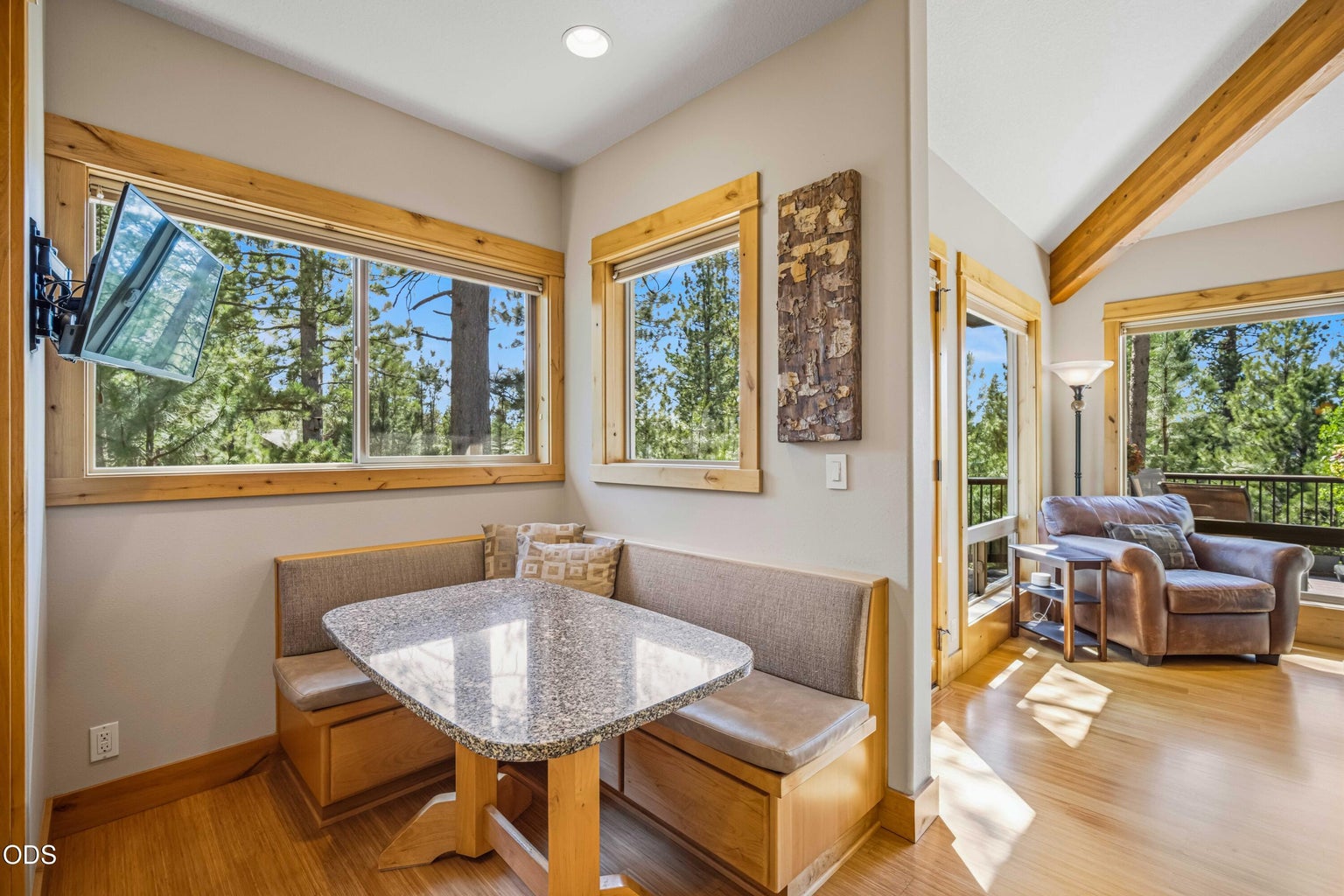 Surrounded by windows, the built-in breakfast nook offers a sunny place for morning coffee, casual meals or conversation while maintaining a direct connection to the kitchen and outdoor living spaces.
