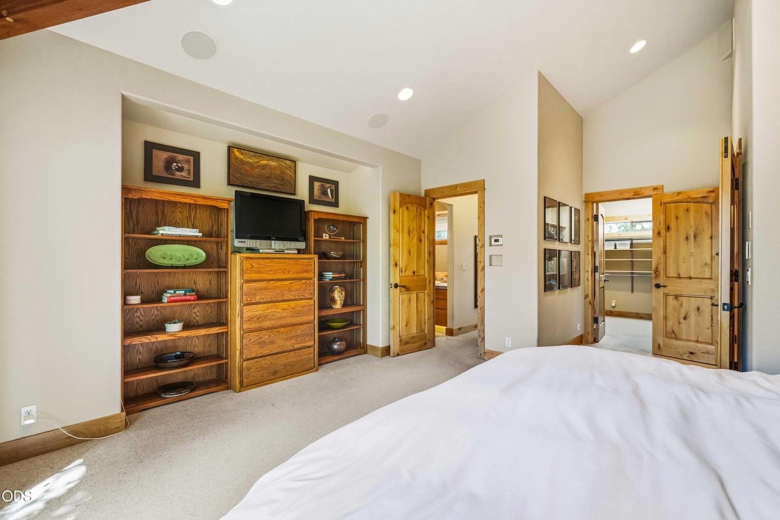 Custom built-ins provide extensive storage and display space within the primary suite, reinforcing the home’s focus on gracious, highly functional full-time living.