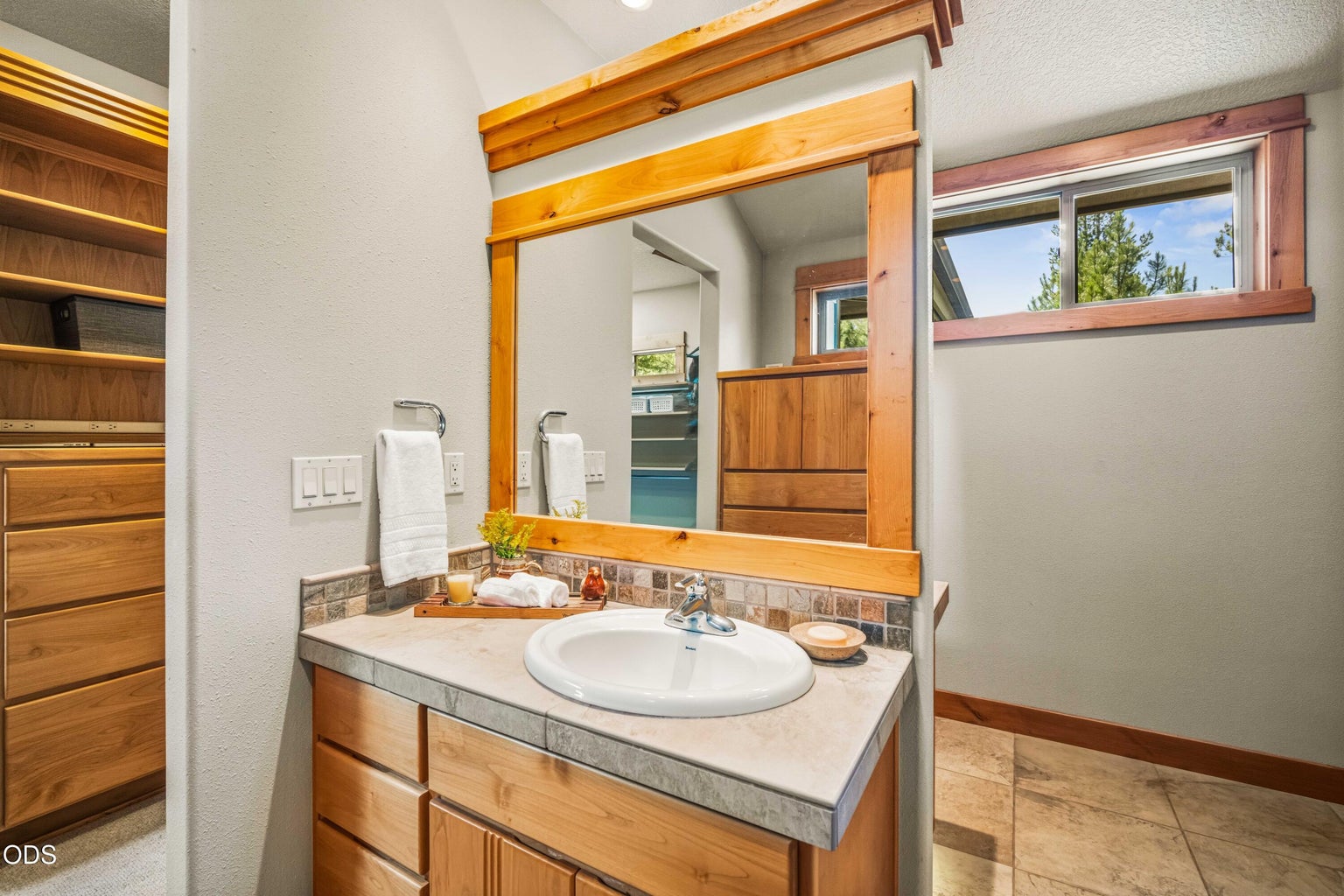 Positioned on the opposite side of the central wall, the second dressing area mirrors the first with a separate vanity, custom cabinetry and generous personal storage, creating distinct and highly functional spaces for two occupants.