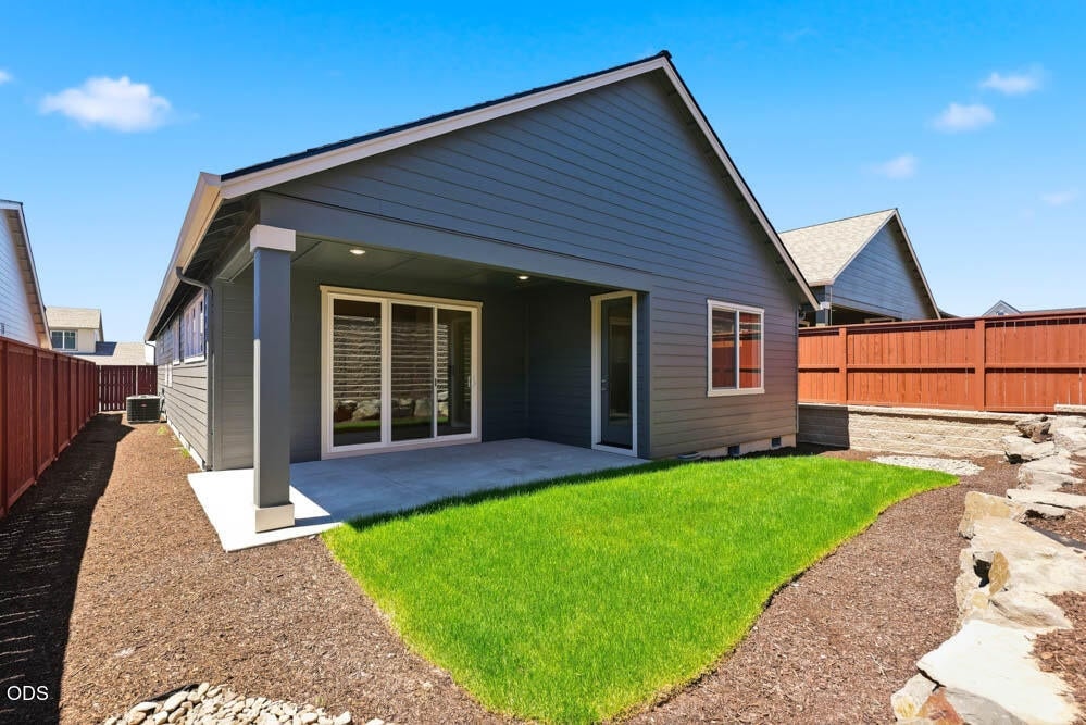 Subject property with upgraded rear landscaping and sprinkler system. Note: upgrade patio door from primary suite.