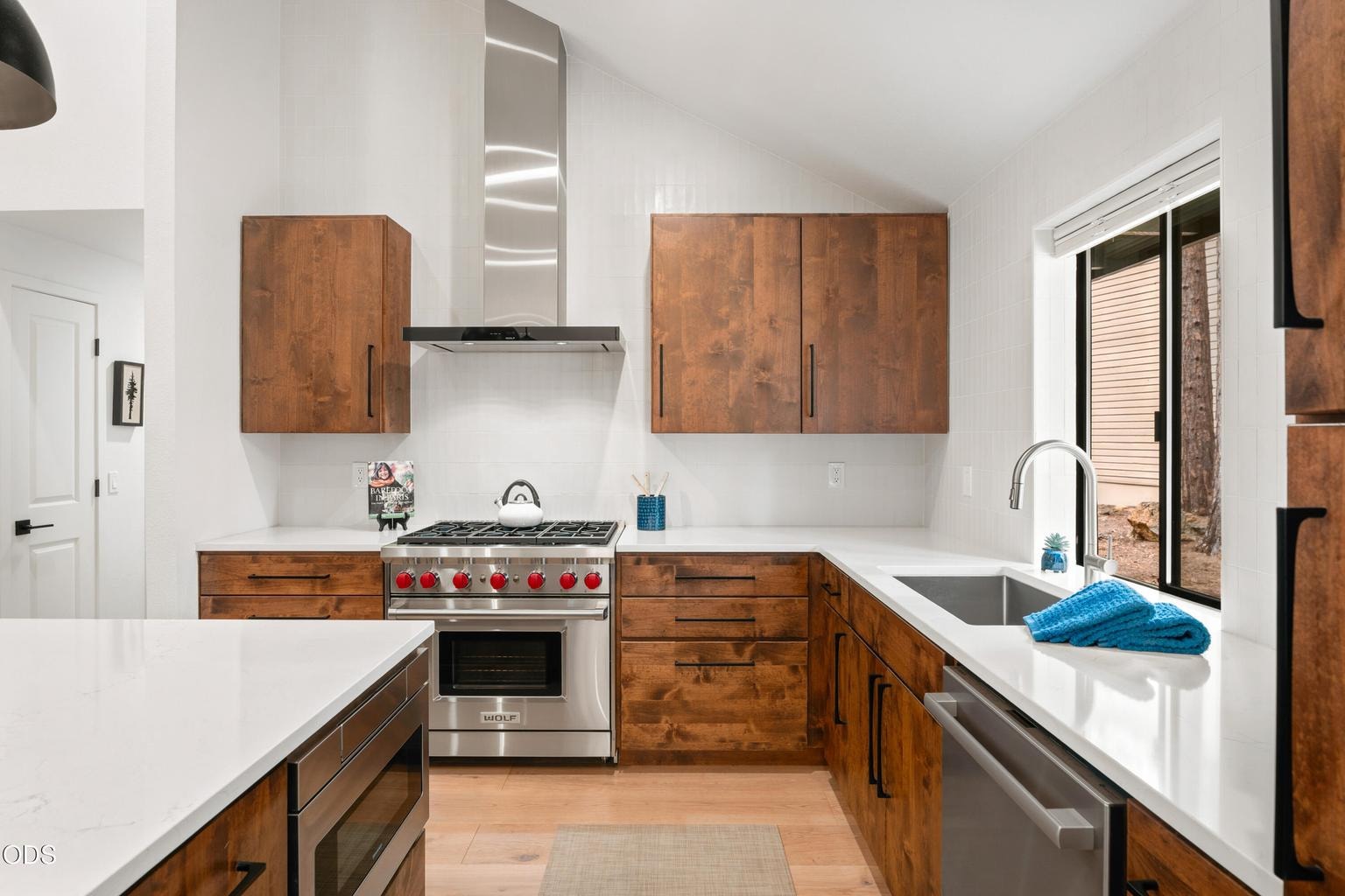 Wolf Range, Bosch Refrigerator & Dishwasher, Zephyr Wine Cooler, Quartz Countertops