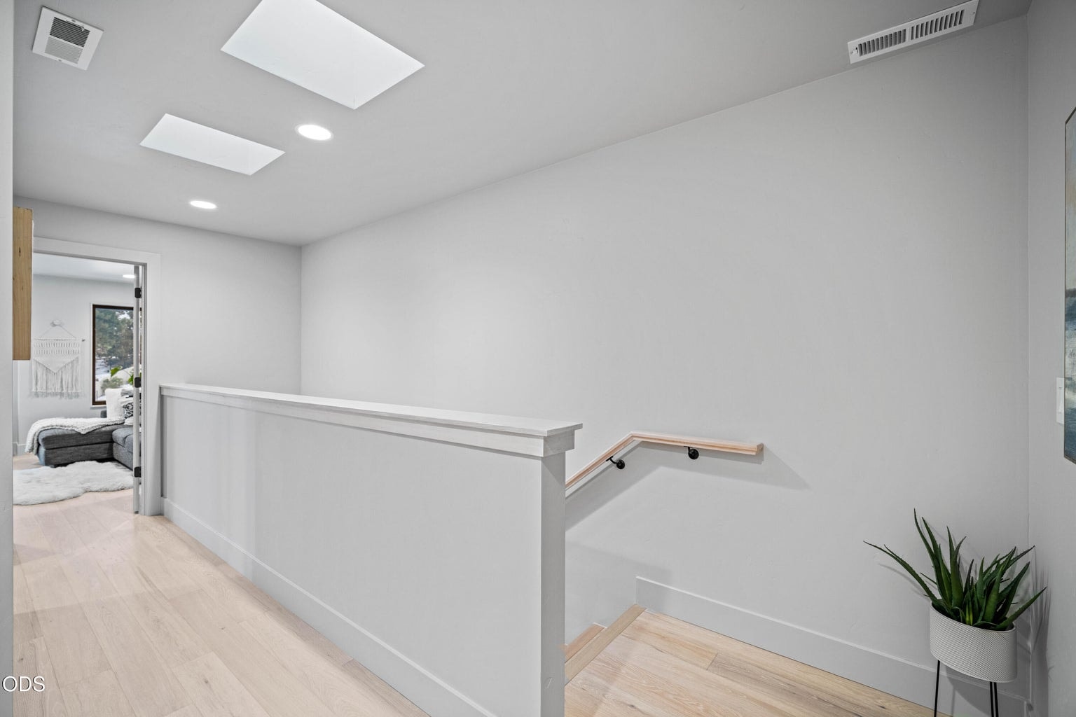 Stairs on upper level with Skylights