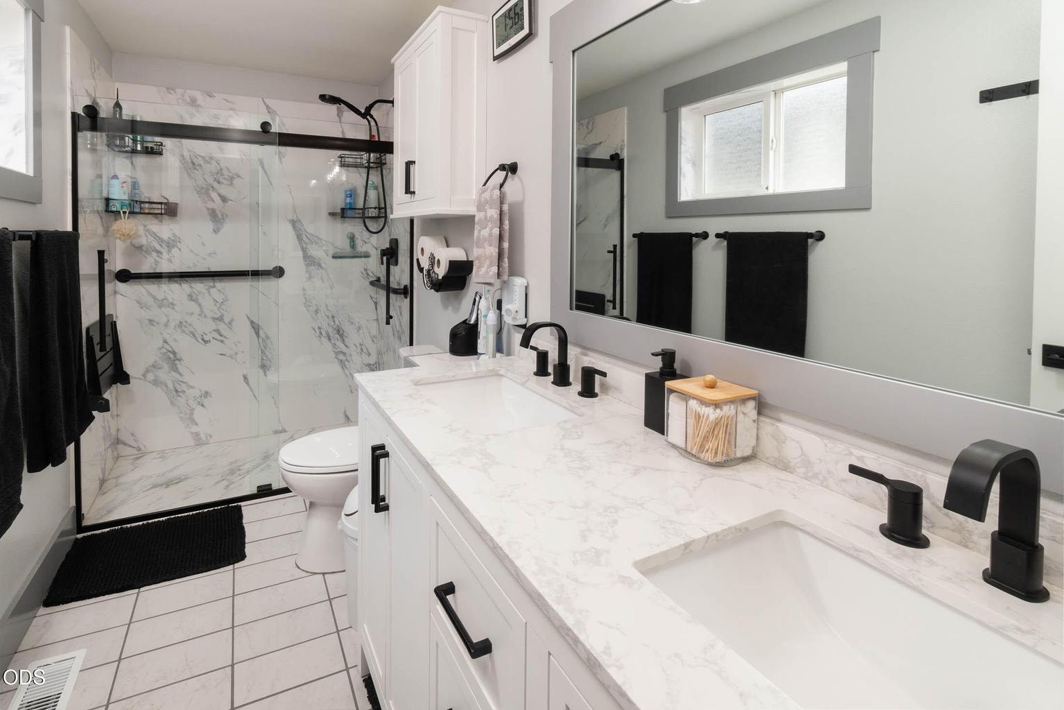 The primary bath features quality new cabinetry, tile flooring, marble quartz counter-top and walk-in shower. There is also a window in this room. The cabinetry is soft-close, the plumbing fixtures are beautiful.