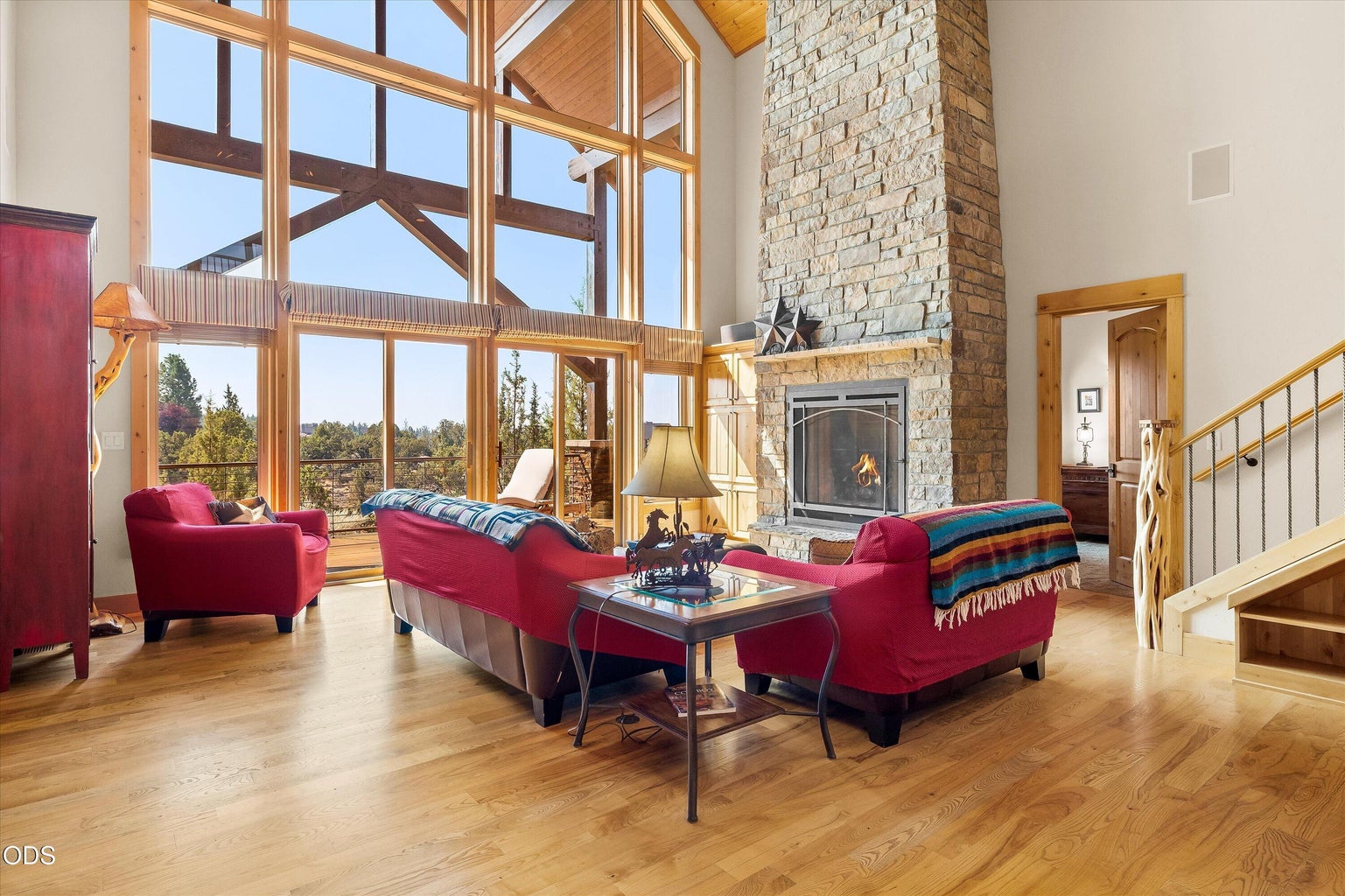 Vaulted ceilings, statement windows, and stone fireplace complete the stately and inviting Great Room