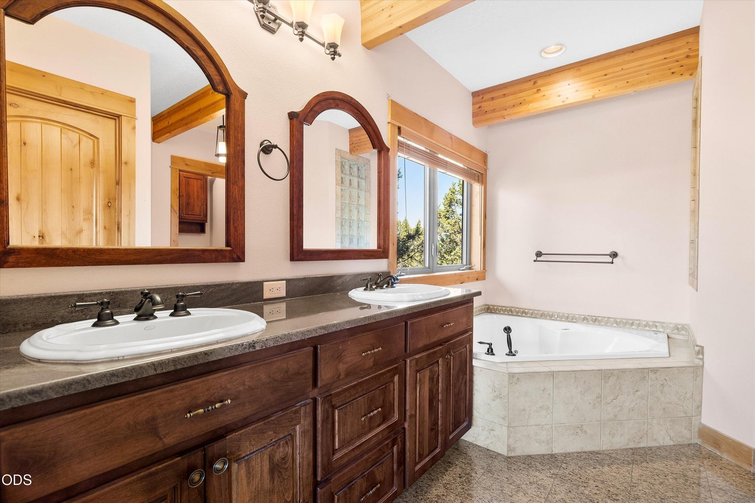 Primary bathroom with double vanity, soaking tub