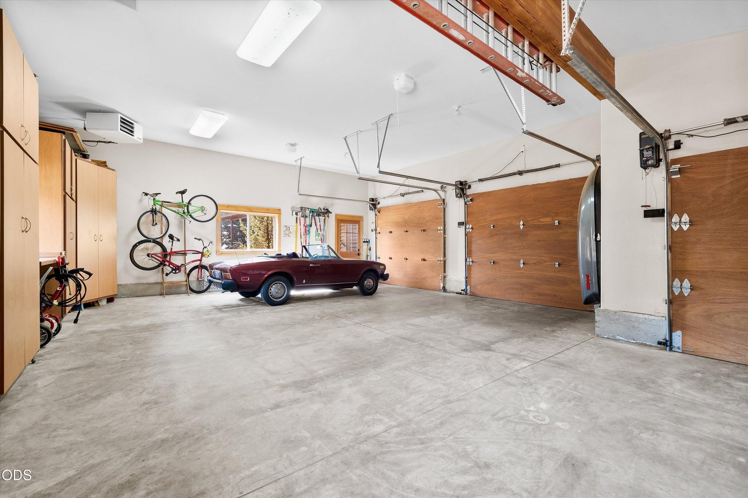 3-car heated garage with plenty of storage and space for working