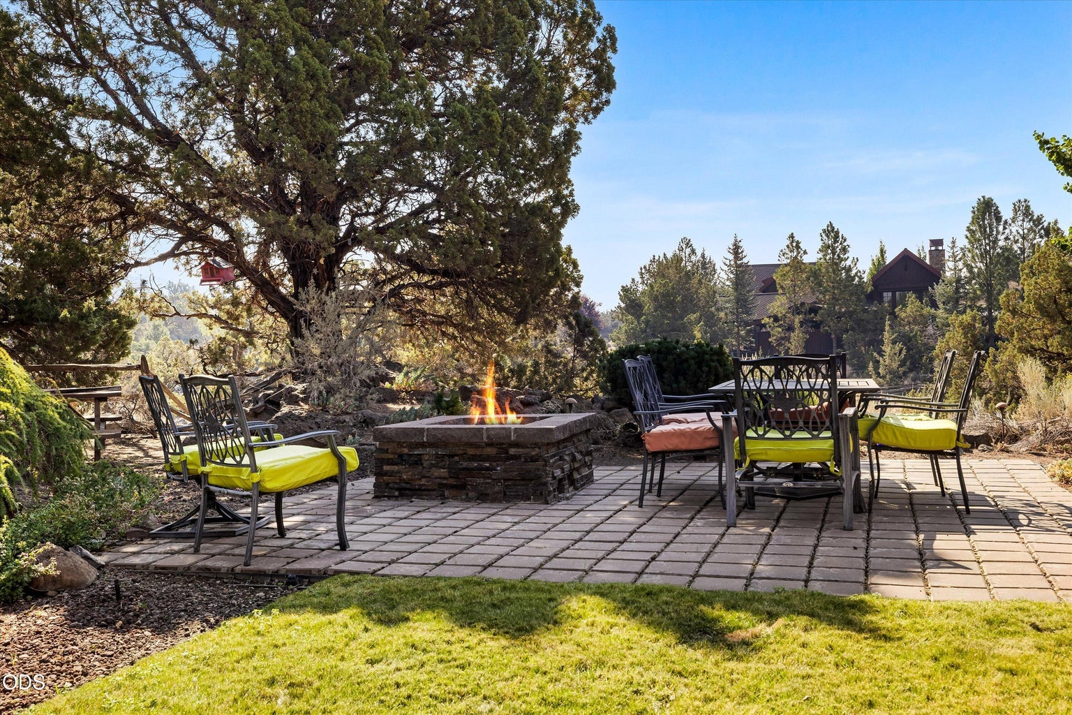 Lawn and paved areas of the backyard extend the outdoor living options