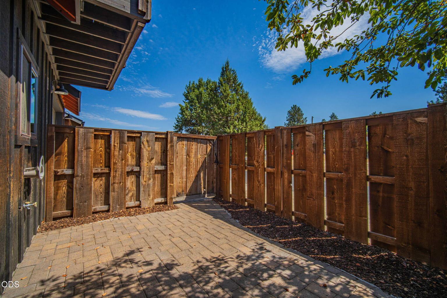 Fully fenced and gated paver patio