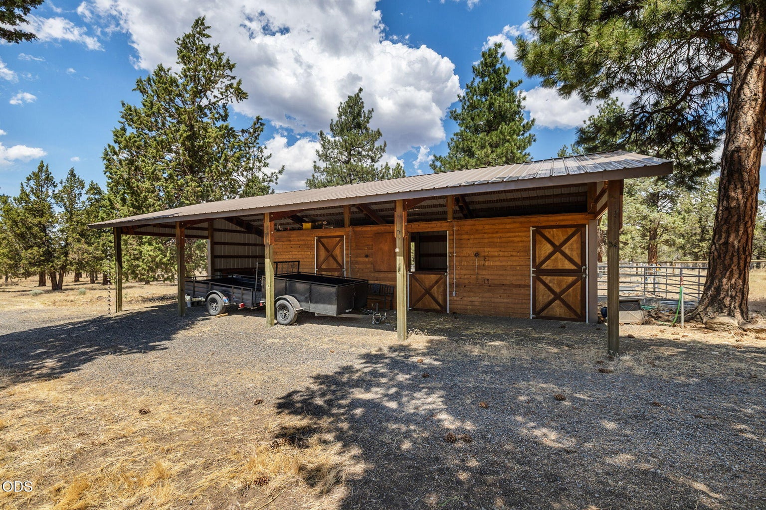 Barn features 2 matted stalls with water & electricity, paddocks, hay storage, tack room and covered storage area. Access to cross-fenced pasture