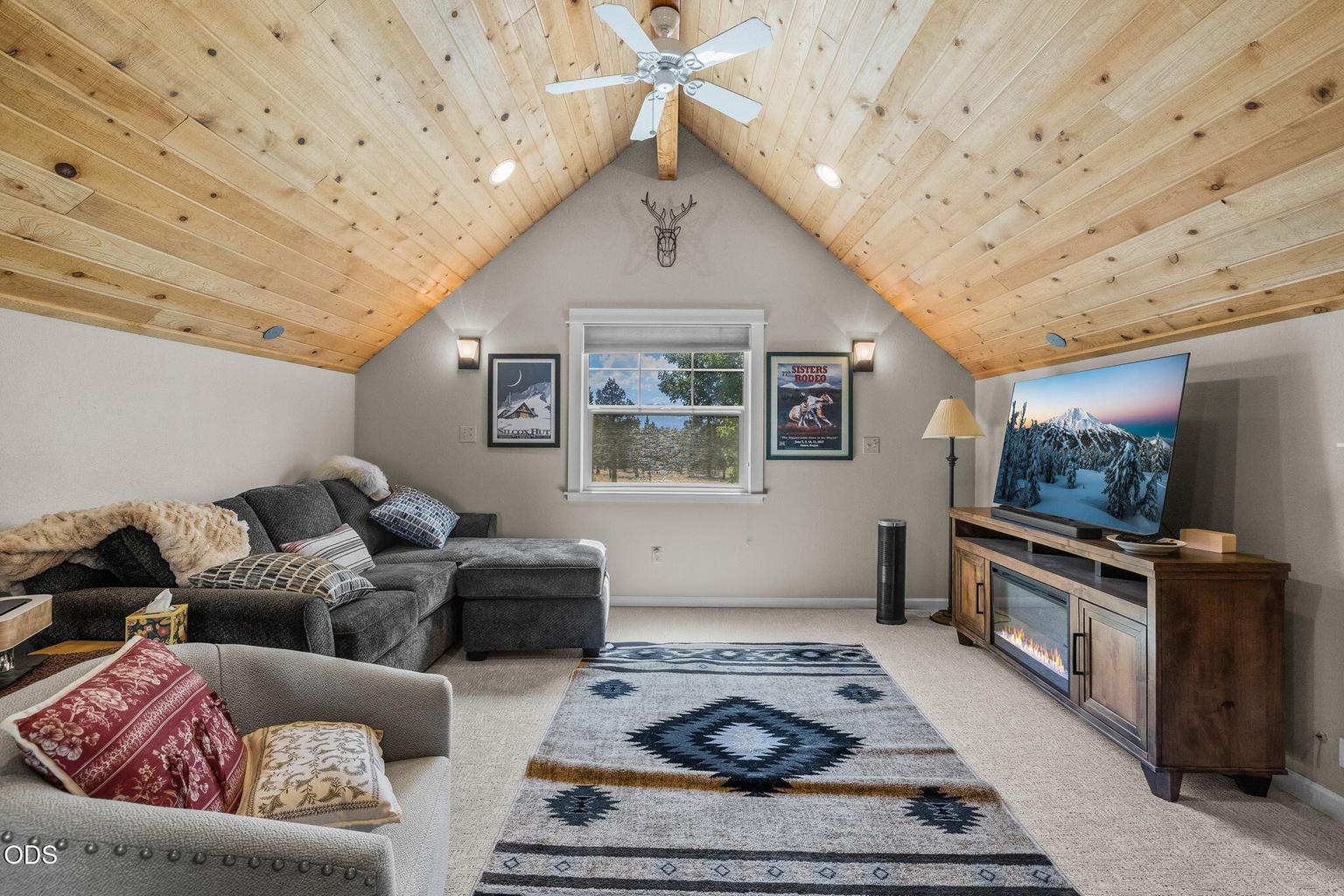 Upper level room with tongue and groove ceiling and mountain views