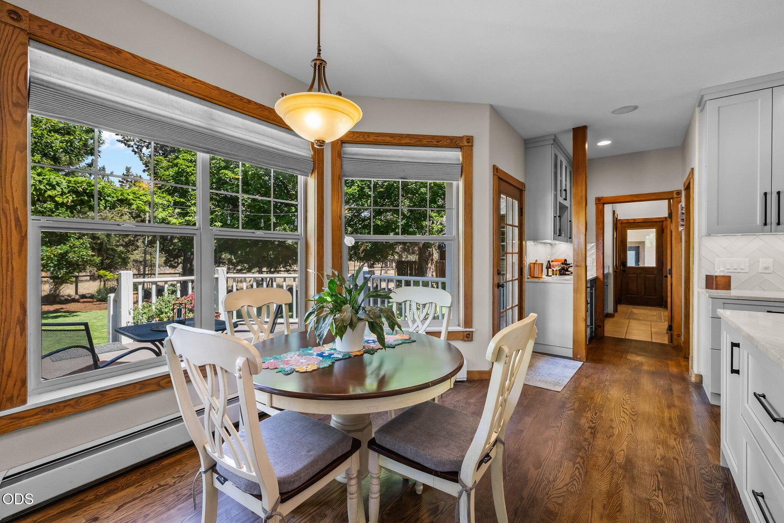 Wall of windows in this kitchen setting with back yard views