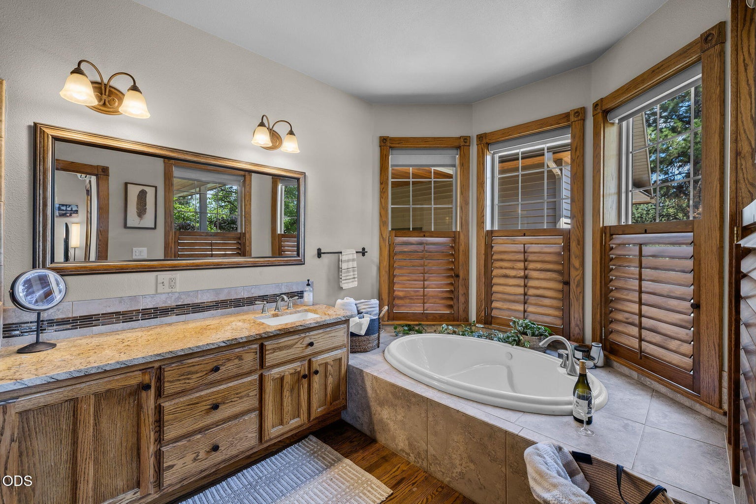 Spacious Primary suite with granite tile show, and soaking tub