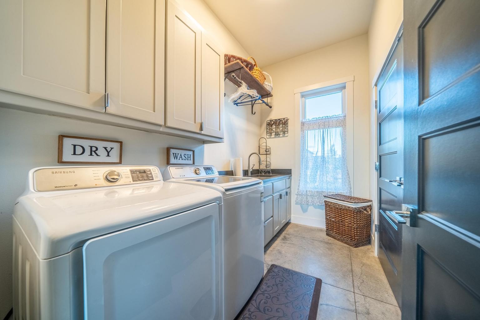 Included washer and dryer with another utility sink and folding/hanging area