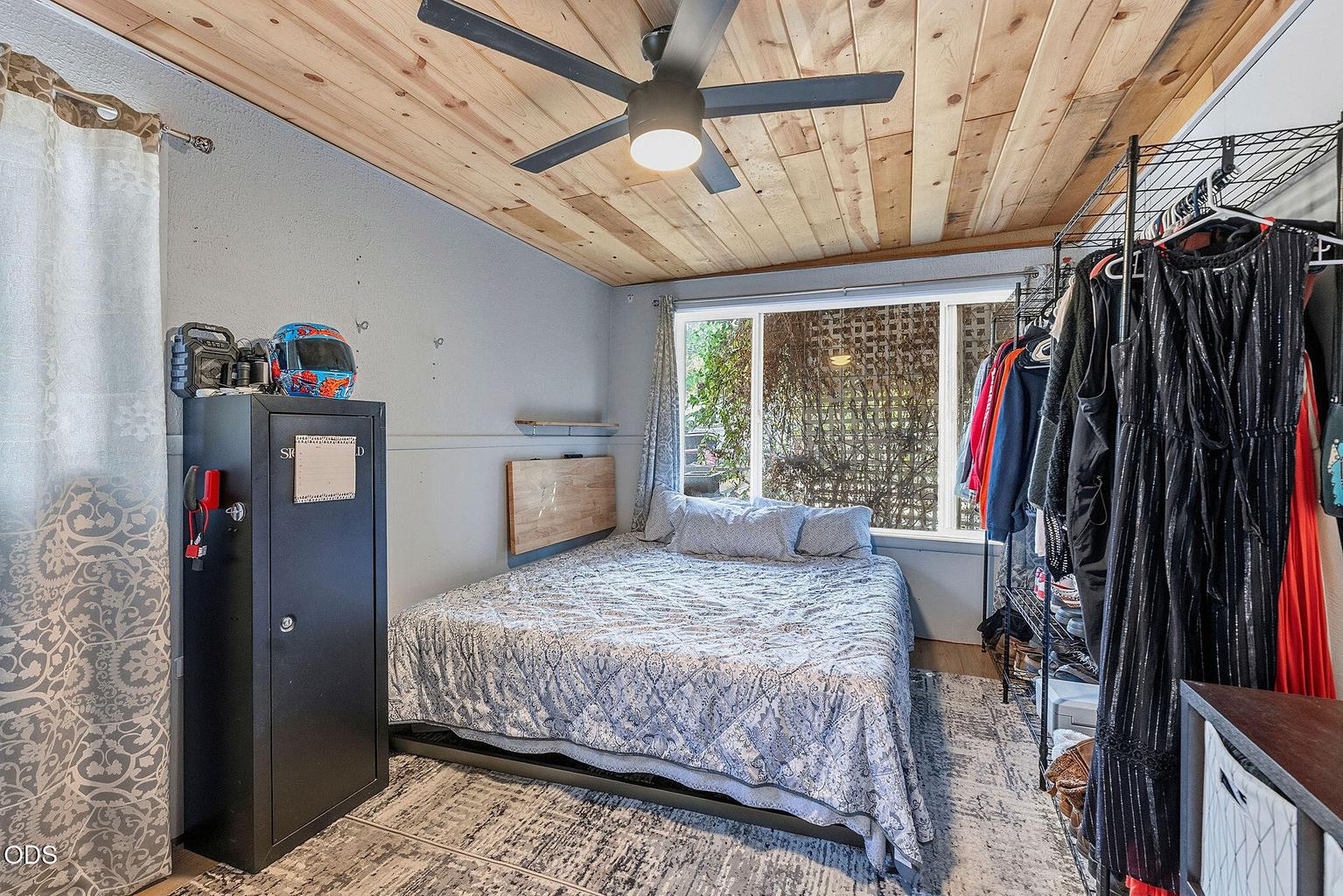 Bedroom with tongue and groove ceilings.