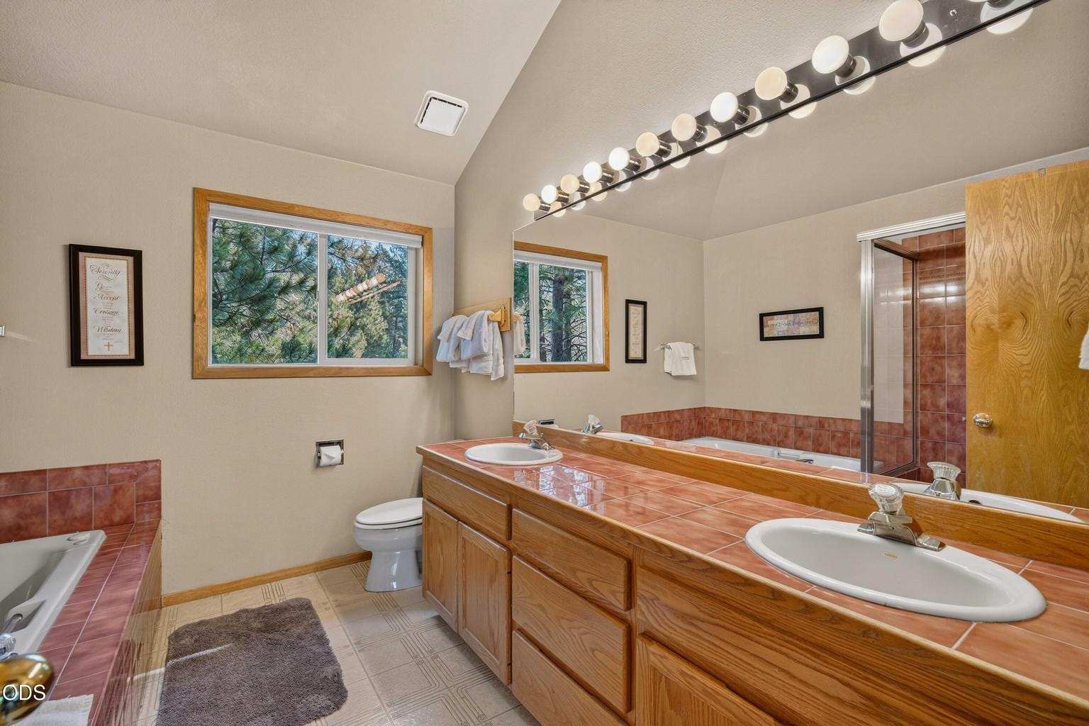 A generous primary bath provides double sinks and room to begin and end the day comfortably.