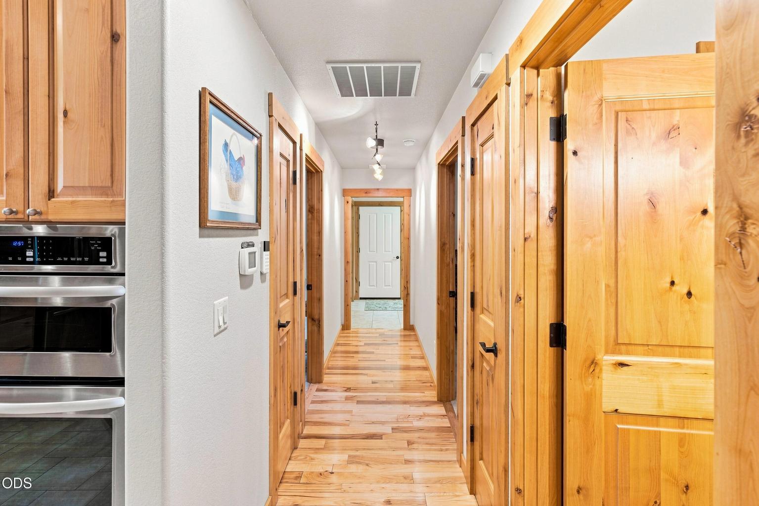 Hallway to 2nd and 3rd Bedrooms and Laundry Room and Attached Garage