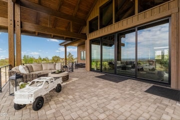 The great room seamlessly opens to an oversized paved, covered patio