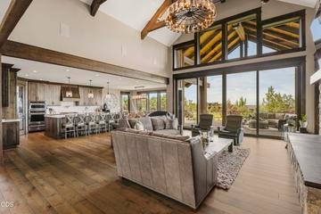 The focal point of the great room are the huge windows drawing the eye up to vaulted ceilings and dual sliding glass doors to fully capture the golf course and mountain views
