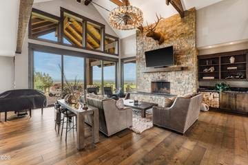 Floor-to-ceiling stone, wood-burning fireplace, custom built-ins and wood beams and mantle, and hardwood floors are only some of the touches that make this home feel natural and wecoming