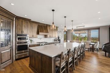 Luxury appliances, oversized Sub-Zero refrigerator with drawer freezer, undercounter double-drawer refrigerator/freezer with automatic ice maker, walk-in pantry, and more complete the inviting kitchen