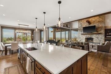 An oversized island welcomes guests and offers easy flow to living and dining