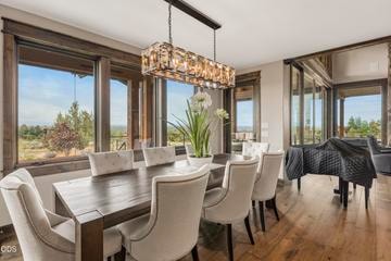 The dining room is bookended by two glass doors leading to the expansive outdoor deck