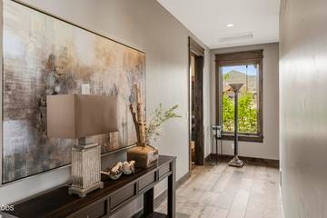 Left of the foyer, a welcoming hallway leads to the office and the second primary bedroom