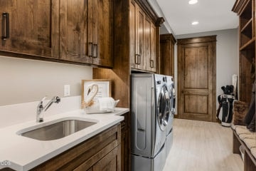 Laundry room with mud sink connect the garage to the home - the primary walk-in-closet opens to the laundry room also