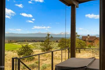Hot tub off the back patio and primary bedroom offer more stunning views