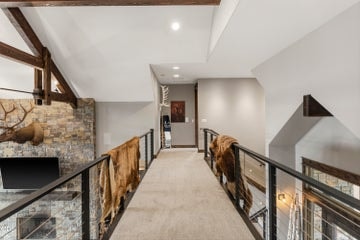 Upstairs, a landing open to the foyer and great room connects a bonus room with kitchenette and bathroom, to the third primary bedroom