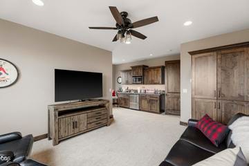 An oversized bonus room with kitchenette (sink, microwave, undercounter double-drawer refrigerator/freezer with automatic ice maker) offers unending options for additional living space, from guest or in-laws quarters to another office, gym, media room, or den, or fourth bedroom